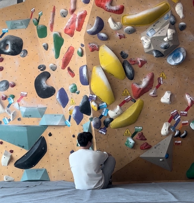 author staring at the bouldering wall